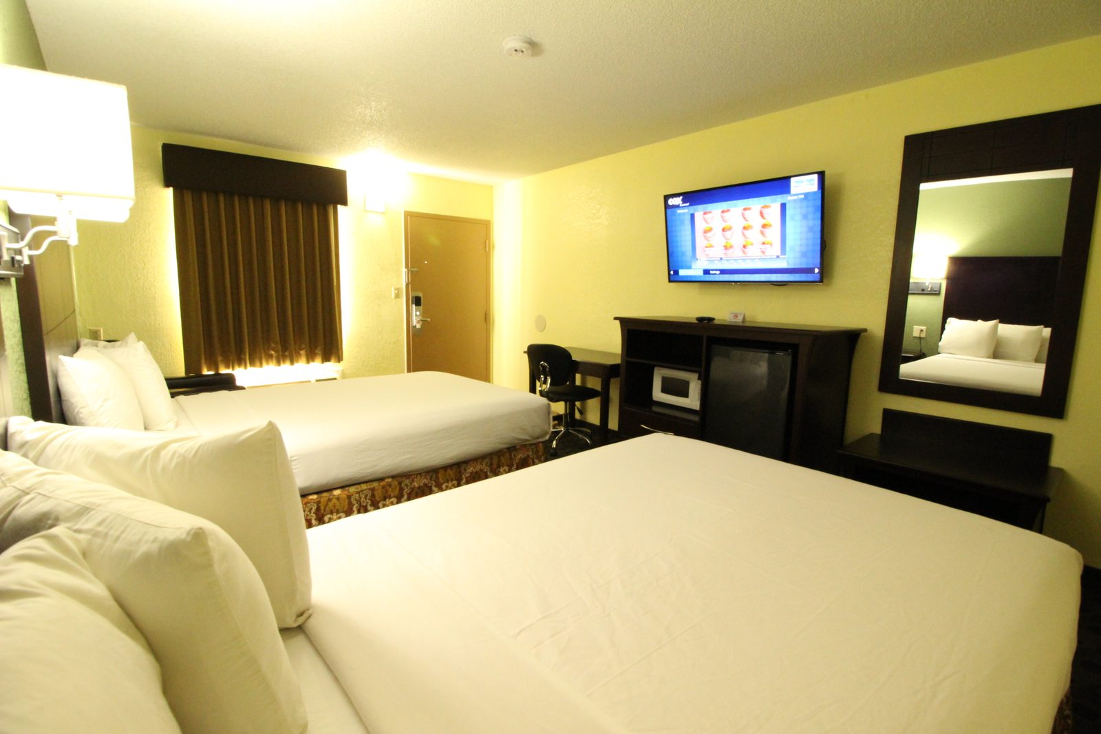 Two queen room with 50-inch LED TV, microwave and refrigerator